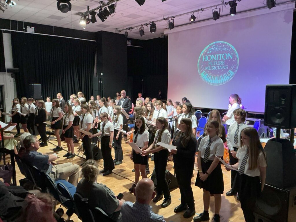 Students performing on stage singing