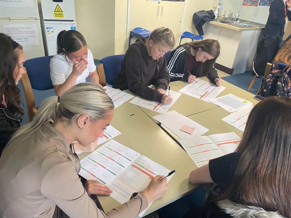 Students filling out workbooks