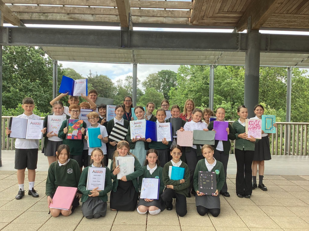 A group of students with their awards and certificates