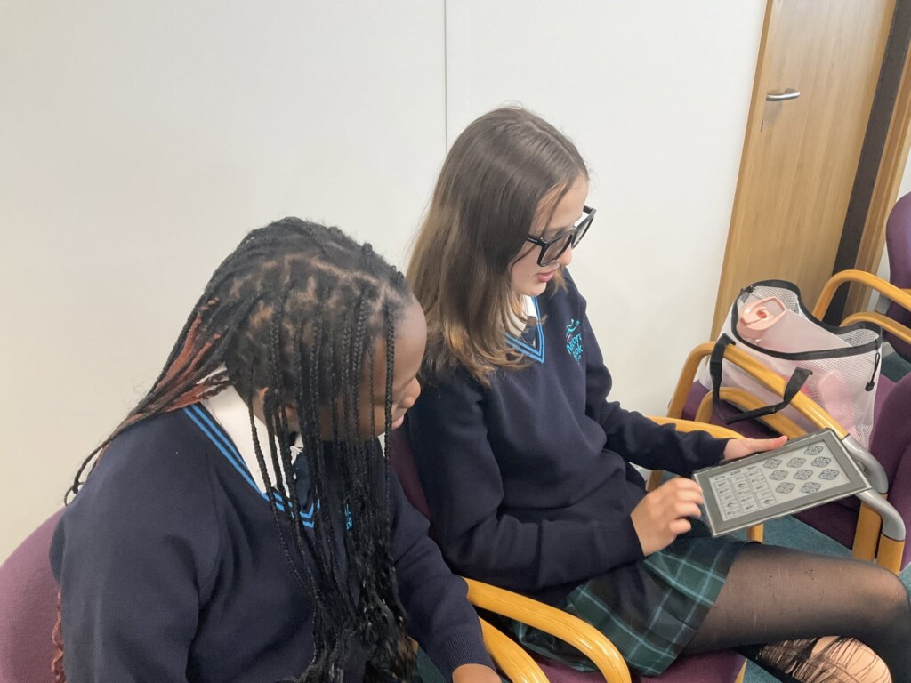 Students exploring vision testing equipment