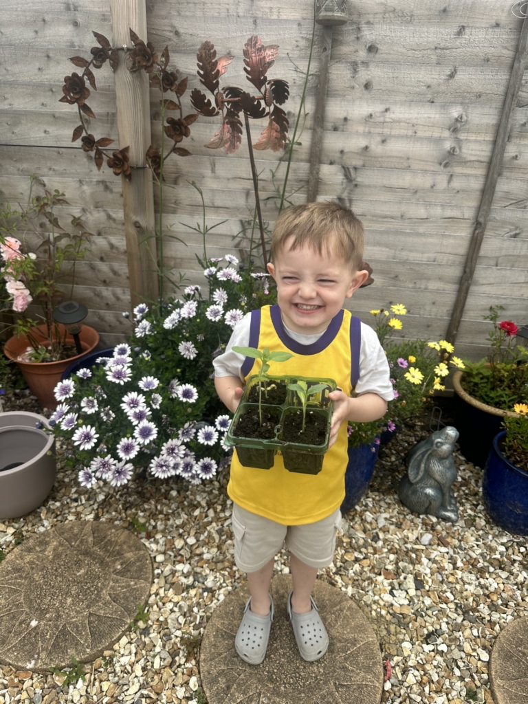 Pupil with a tray of plants