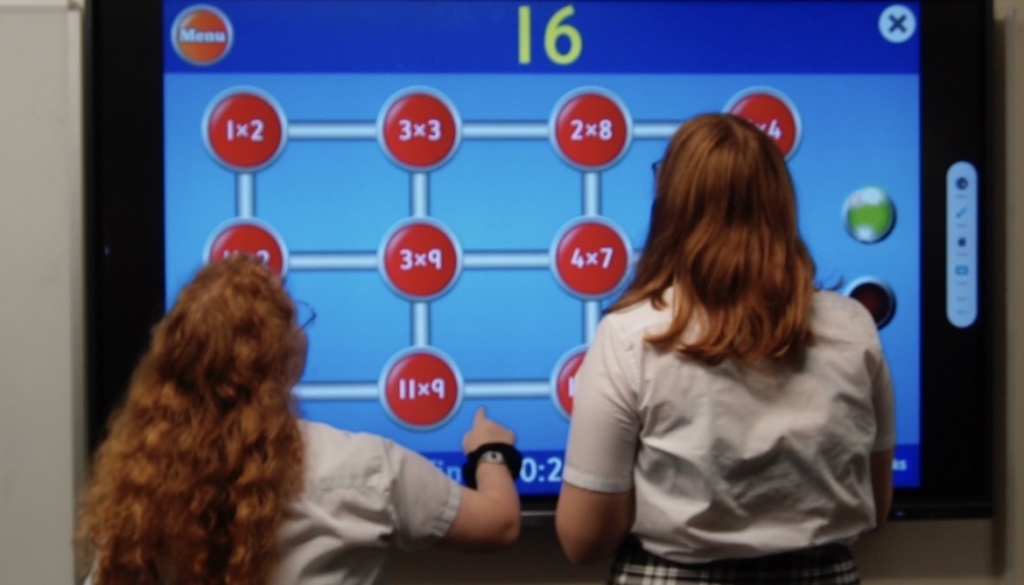 Two students playing an interactive online maths game