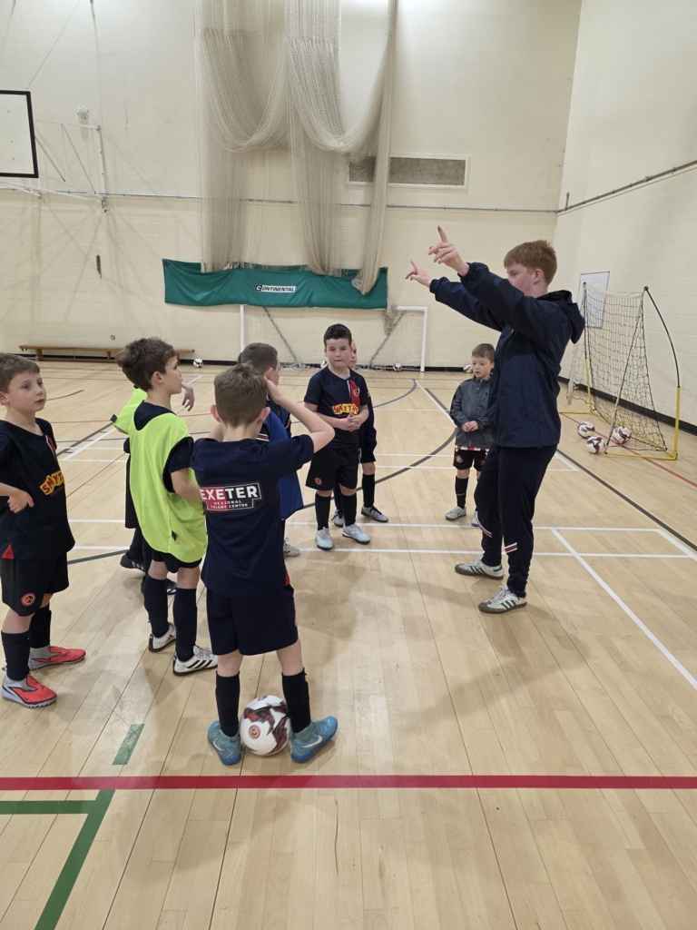 A student leading a session for younger children