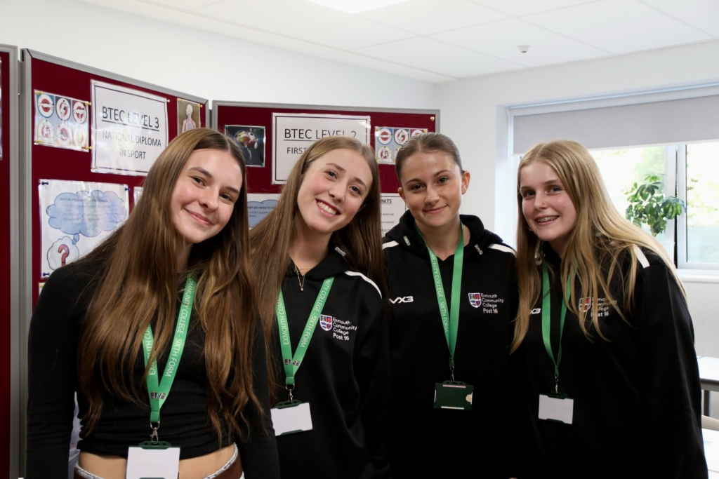 A group of 4 sixth formers smiling at the camera, wearing their Exmouth College hoodies.