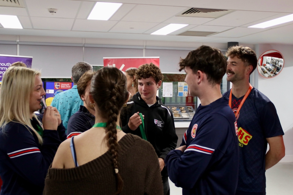 Sixth form helpers chatting with visitors