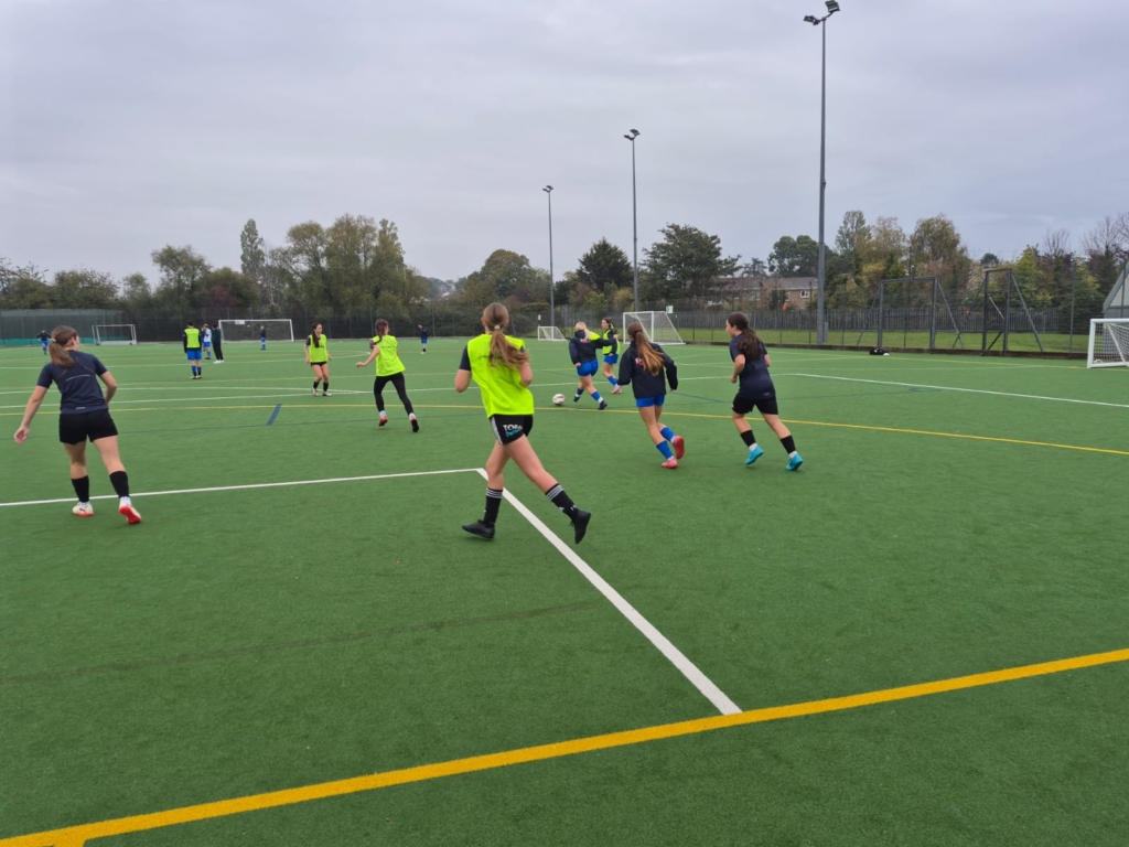 Girls playing football on the pitch