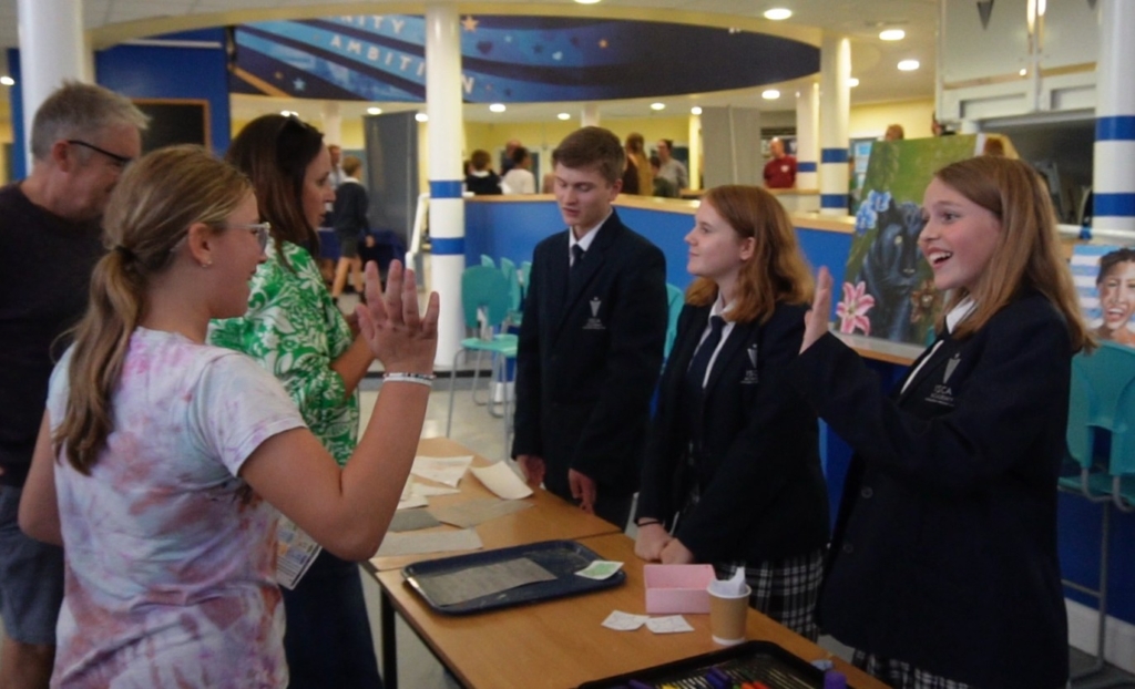 Students greeting visitors
